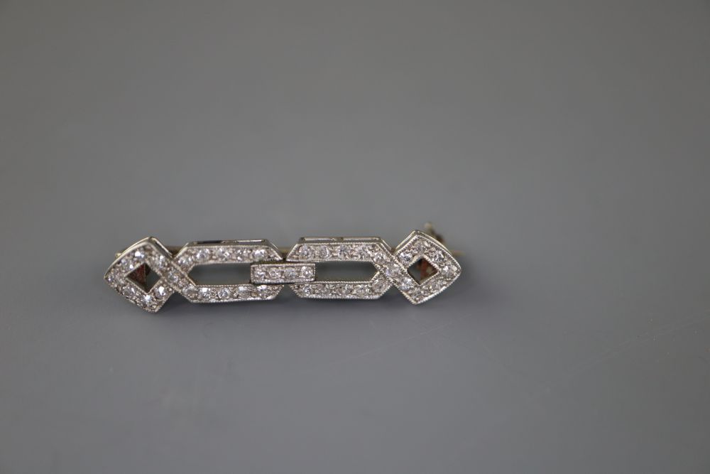 A 1920s white metal and diamond set openwork brooch, 31mm, gross 2.8 grams, with a Tessier box.